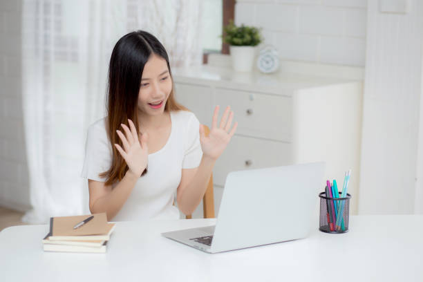 istock Young asian business woman using laptop computer for video call online hello and communicate work from home, girl conference with notebook and say hi, social distancing, communication concept. 1314911345