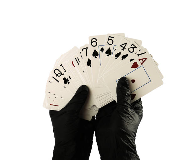 istock Playing cards in hand isolated on white background 1314912679
