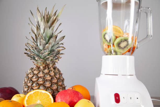 istock White blender with fresh fruits on the table. 1314915371
