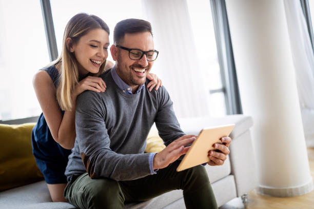 istock Happy couple in love having fun with digital tablet 1314917774