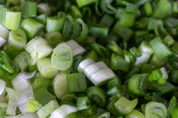 istock chopped spring onion with knife, food background texture. 1314918796