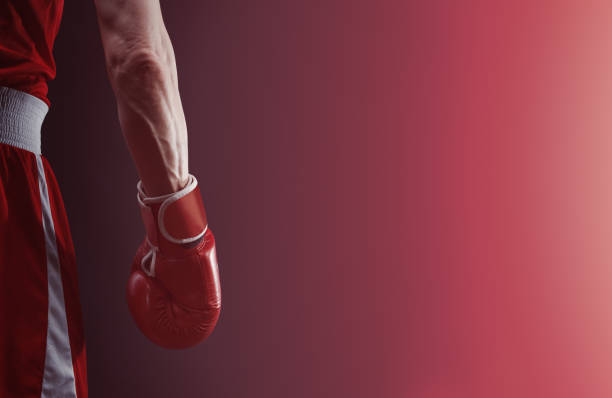 istock The hand in a boxing glove on a dark background. 1314919749