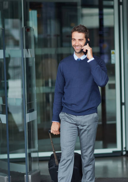 istock Cropped shot of a handsome young businessman on the move with a suitcase while using his cellphone during the day 1314920994