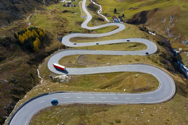 Aerial view of a winding mountain road with car traffic, Julier Pass, Graubunden Canton, Swiss Alps.