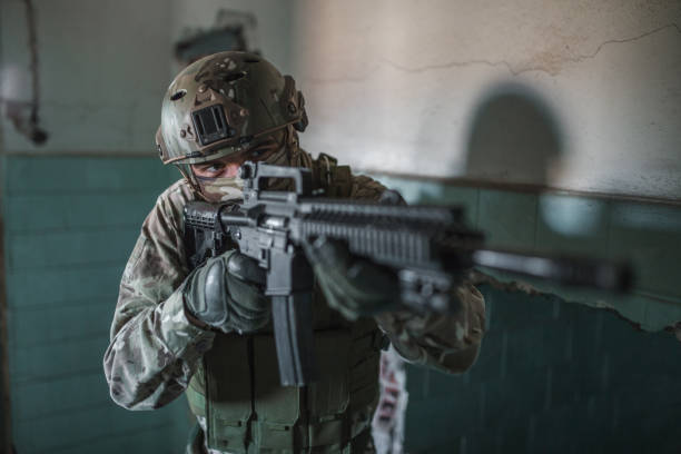 istock Special forces soldier in camouflage uniform aiming with rifle in war zone 1314925106