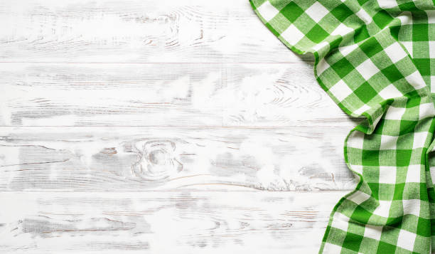 istock White wooden table covered with green tablecloth. 1314925391