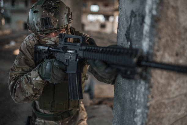 istock Special forces soldier in camouflage uniform aiming with rifle in war zone 1314925448