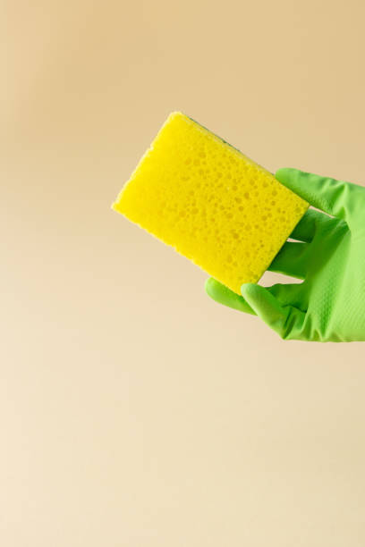 istock Hand in rubber glove holds dishwashing sponge 1314925479