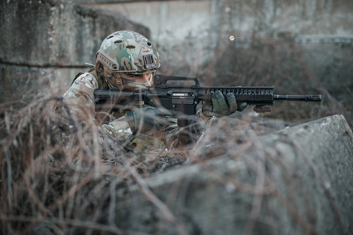 Army sniper military operation battle looking through the scope in the field