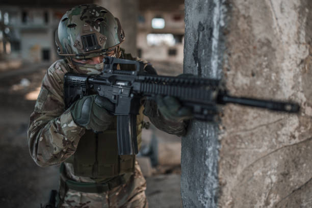istock Professional soldier in camouflage uniform aiming with rifle in war zone 1314926259