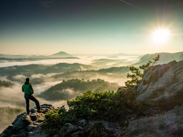 istock Single Man Hiker On A Mountain Trail. Mountain Look Into Misty Valley 1314926353
