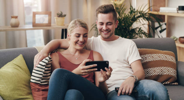 istock Shot of a young couple using a smartphone on the sofa 1314926442