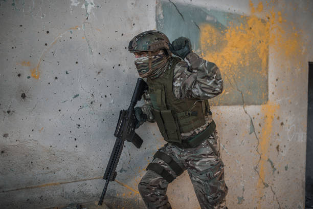 istock Armed soldier in camouflage uniform fighting in war zone 1314926958