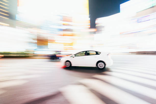 Tokyo, Japan - December 13, 2015: Abstract image of a White Toyota Prius  at the Shibuya Crossing in Tokyo, Japan.