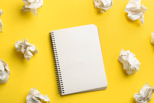 istock Notebook and crumpled sheets of paper on yellow background, flat lay. Space for text 1314930777