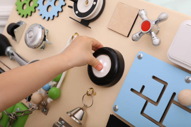 istock Little child playing with busy board, closeup 1314931200