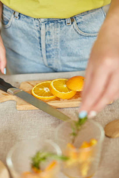 istock Female hand put rosemary in glasses, making fresh lemonade 1314934740