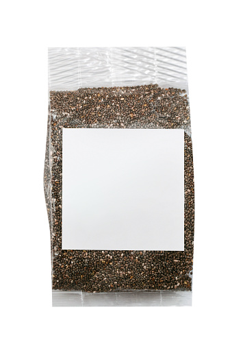 Dark seed in plastic bag with blank label, white background, clipping path