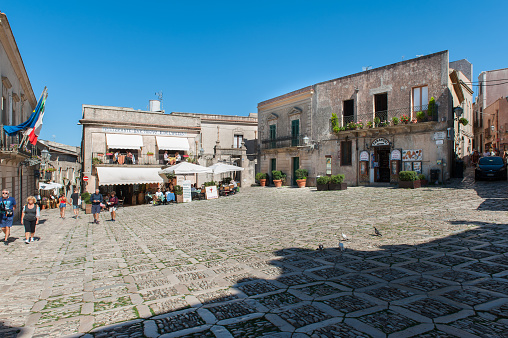 The Piazza della Loggia is a small square with tourist info office, shop, terrace and restaurant in the city of Erice. Erice is located on the top of a hill overlooking the Trapani province on Sicily.