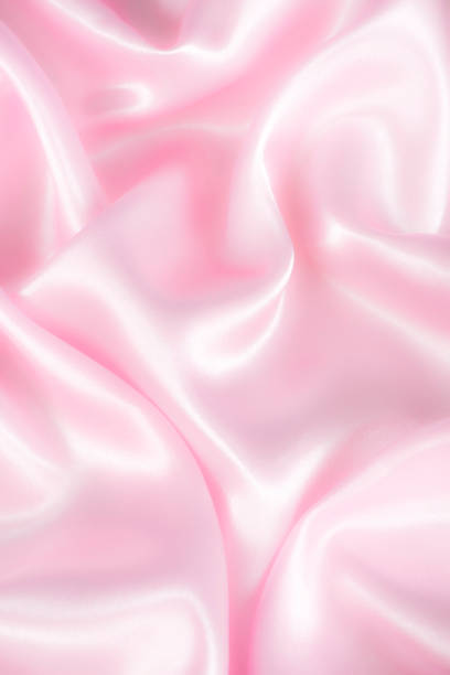 istock Abstract pink silk fabric texture background. Cloth soft wave. Creases of satin 1314938737