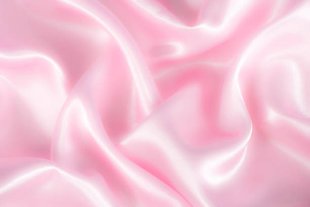 istock Abstract pink silk fabric texture background. Cloth soft wave. Creases of satin 1314938868
