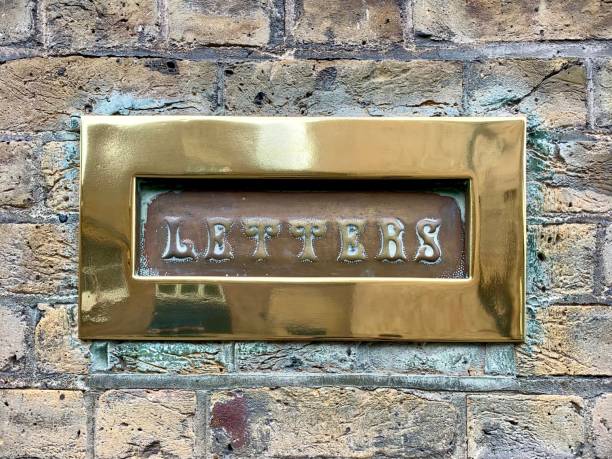 istock LONDON, ENGLAND. Brick wall with vintage letter hole for envelopes and small parcels. 1314938925