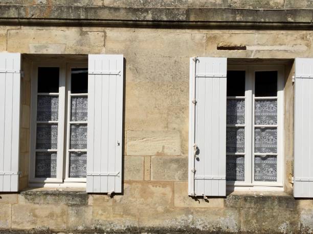 istock SAINT EMILION, FRANCE. Stone shabby wall with two windows. 1314939005