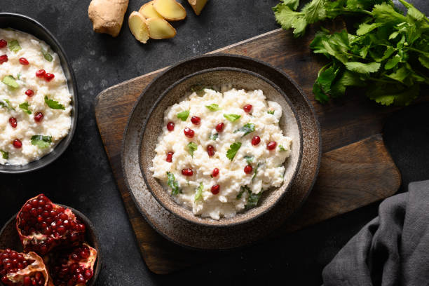 istock Curd Rice with pomegranate, cilantro, ginger on a black background. 1314941198