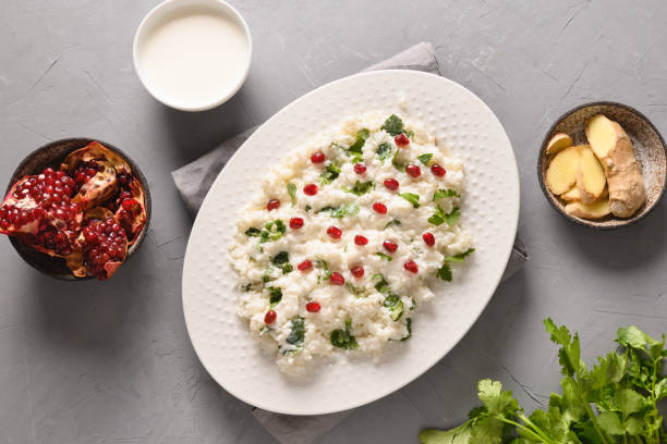 istock Curd Rice with pomegranate, cilantro, ginger on a grey background. 1314941200