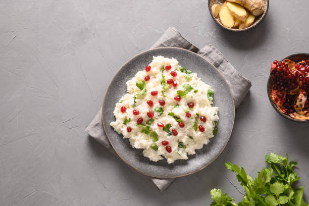istock Curd Rice with pomegranate, cilantro, ginger on a grey background. 1314941206