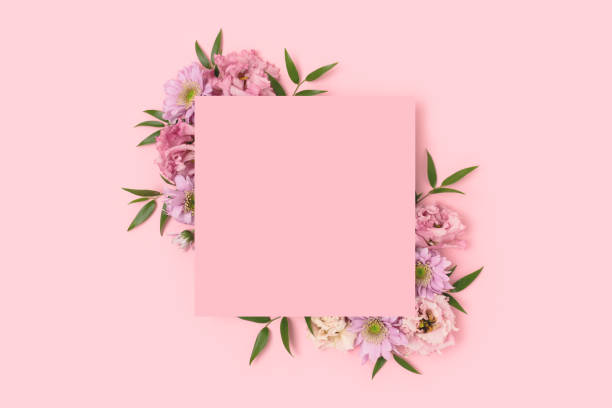 istock Empty square paper card with border frame made of eustoma flower on a pink pastel background. 1314941964