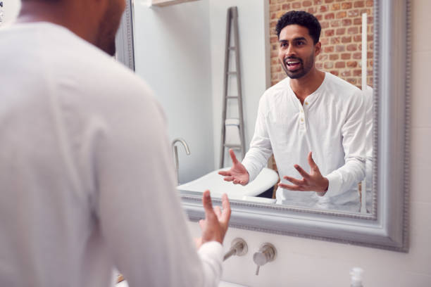 istock Man At Home Practising Giving Speech Or Presentation In Bathroom Mirror 1314946829