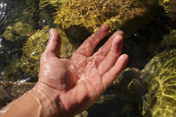 istock Hand and natural mountain waters 1314946935