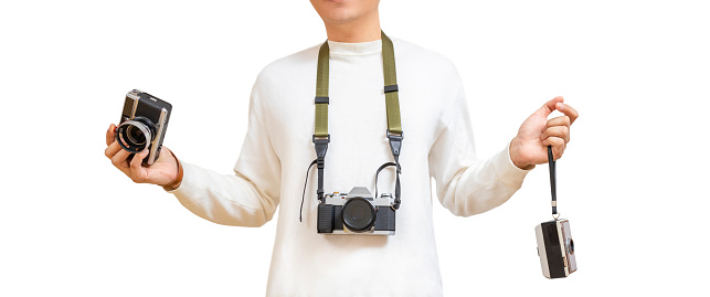 man in white t-shirt holding rangefinder camera, compact camera and hanging DSLR camera on neck. isolate on whte. photography concept