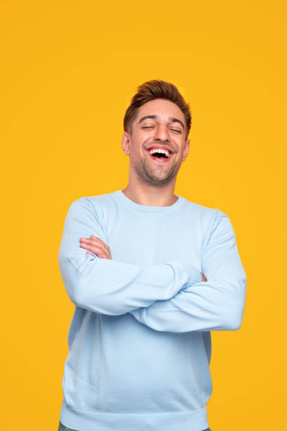 istock Laughing young man with arms crossed 1314949430