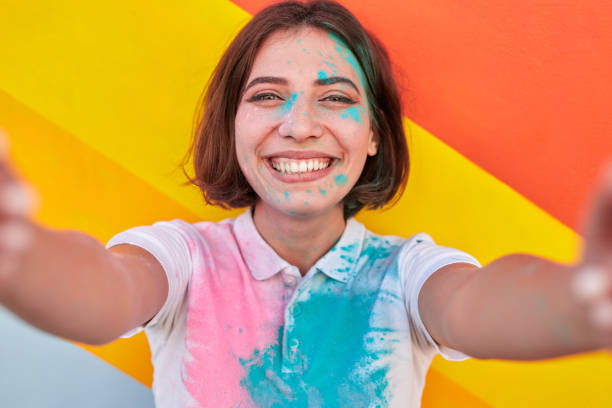 istock Cheerful female hipster taking selfie during paint party 1314949497