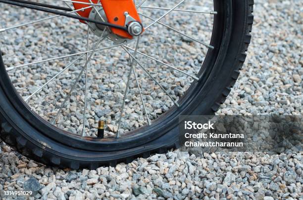 Close Up Of Flat Tire Bicycle On Dirt Road With Selective Focus Stock Photo - Download Image Now