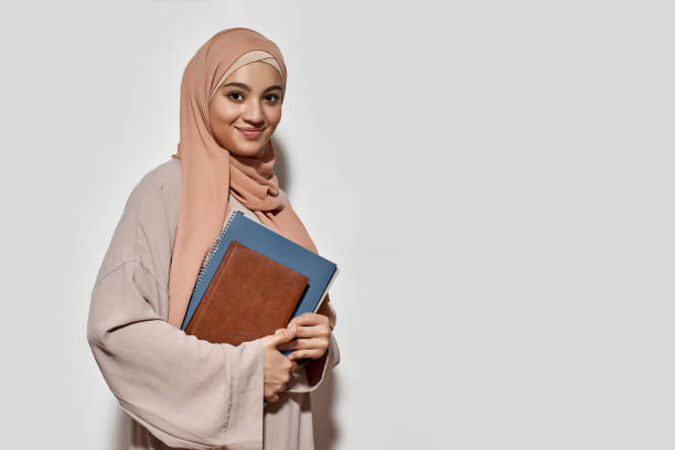 istock Smiling young arabian woman in hijab with copybook 1314951932