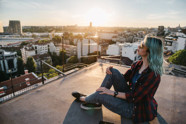 istock Woman sitting on a rooftop 1314955007