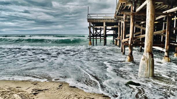 istock crashing waves at the pier 1314956197
