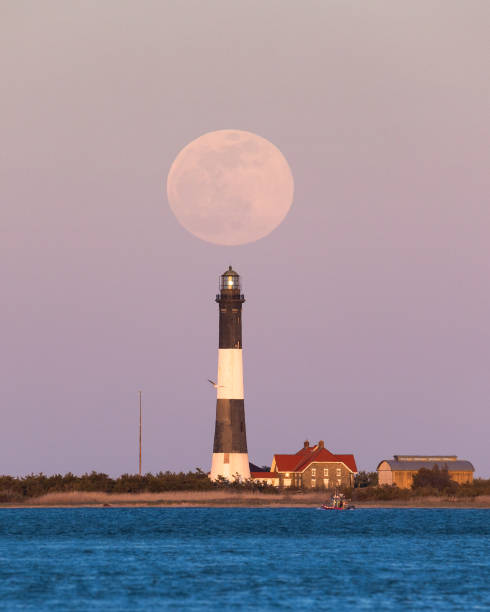 istock Full moon rising behind the Fire Island Lighthouse 1314956653