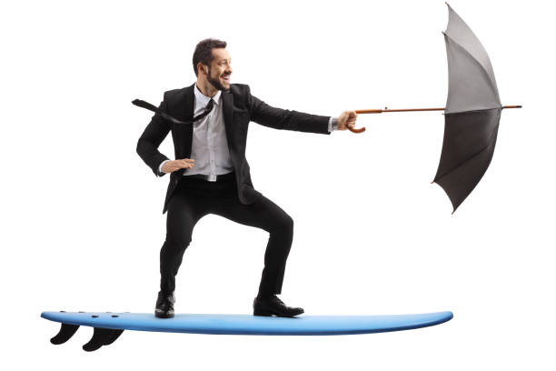 istock Businessman riding a surfboard and holding an umbrella 1314957539