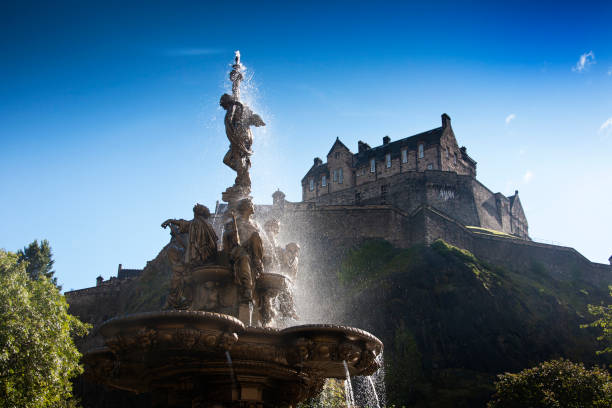 View from West Princes Street Gardens, of the historic Edinburgh Castle towering over Ross Fountain in Edinburgh, Scotland.