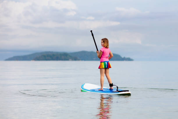 istock Child on stand up paddle. Water and beach sport 1314960399