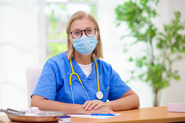 istock Doctor or nurse with stethoscope and face mask. 1314960947