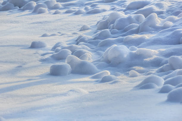 Real natural snow round pieces in cold blue winter day