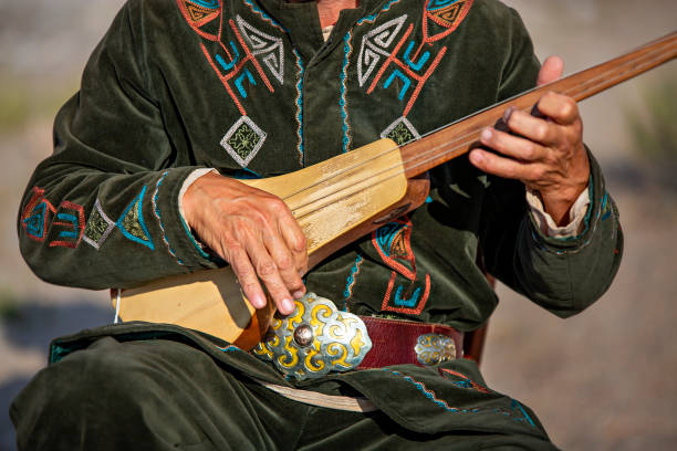 Kyrgiz musical instrument of Komuz in Issyk Kul, Kyrgyzstan Issyk Kul, Kyrgyzstan - August 31, 2019: Traditional stringed musical instrument known as Komuz in Issyk Kul, Kyrgyzstan bishkek photos stock pictures, royalty-free photos & images