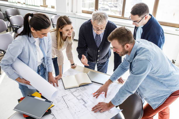 istock College professor examining blueprint with group of his students 1314963099