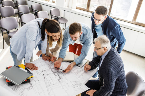 istock College professor examining blueprint with group of his students 1314963164