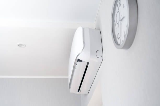istock Air conditioning on a white wall with a close-up clock in a modern room 1314963462